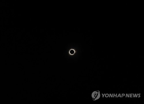 A total solar eclipse is pictured from the city of Ternate, in Indonesia's Maluku Islands, on March 9, 2016.  A total solar eclipse swept across the vast Indonesian archipelago on March 9, witnessed by tens of thousands of sky gazers and marked by parties, Muslim prayers and tribal rituals.   / AFP / BAY ISMOYO