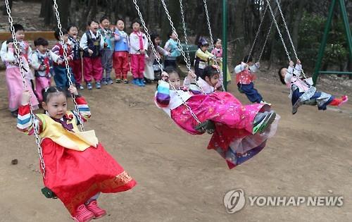 4일 부산 서구 내원정사 유치원에서 어린이들이 설을 앞두고 그네타기 등 민속놀이를 즐기고 있다.