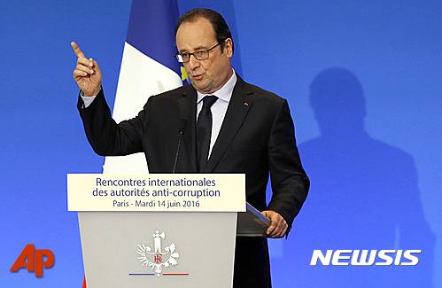 French President Francois Hollande gestures during the opening of the International Anti-Corruption Practitioner Conference at The Organisation for Economic Co-operation and Development (OECD) in Paris, Tuesday, June 14, 2016. Hollande held an emergency security meeting about what he said was "incontestably a terrorist act" after a Frenchman killed two police officials Monday night in a Paris suburb. (Francois Guillot, Pool via AP)