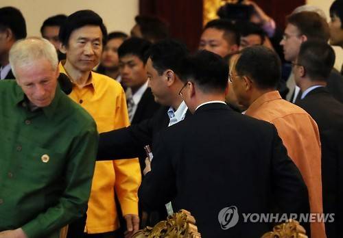 25일 오후(현지시간) 라오스 비엔티안 돈찬팰리스 호텔에서 열린 환영만찬에서 윤병세 외교장관이 입장하던 중 북한 리용호 외무상과 마주치고 있다.