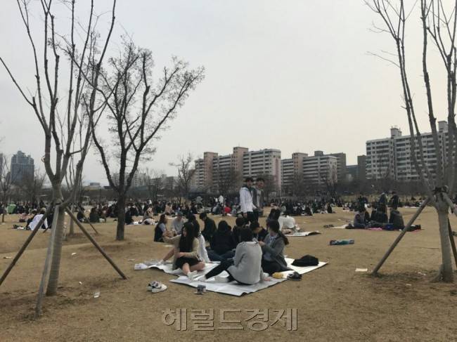 날씨가 풀리자 한강공원 등에서 소풍을 즐기는 시민들이 많아졌다. 사람들이 많아지다보니 흡연이나 과도한 음주로 인한 불편도 늘고 있다. 서울시와 시의회는 한강공원을 포함한 공원 등을 금연구역과 음주 청정구역으로 지정하려고 하지만 시민들의 반발이 심해 진전을 보지 못하고 있다. 지난 26일 여의도 한강시민공원에서 치맥을 즐기는 시민들. 임정요 기자/kaylalim@heraldcorp.com
