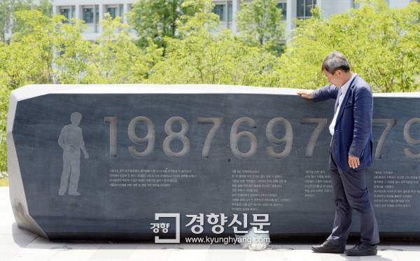 1987년 6월9일 서울 연세대 정문에서 경찰 최루탄을 맞고 쓰러진 이한열 열사를 부축했던 이종창씨가 지난 5일 연세대 내 이한열 열사 기념비를 쓰다듬고 있다. 기념비에 새겨진 ‘198769757922’는 이 열사가 쓰러진 1987년 6월9일, 사망한 7월5일, 장례식 날인 7월9일, 22세이던 당시 나이를 의미한다. 강윤중 기자 yaja@kyunghyang.com