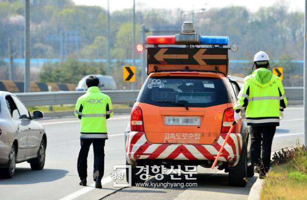 한국도로공사 안전순찰 직원들이 고속도로에 떨어진 물건을 처리한 후 순찰차량으로 돌아가고 있다./정지윤기자