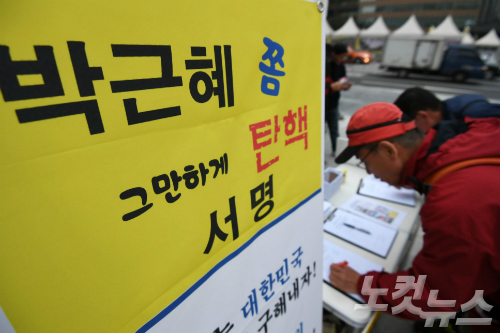 26일 오후 서울 종로구 광화문광장 인근에서 박근혜 대통령 탄핵을 촉구하는 시민들이 서명을 하고 있다. (사진=이한형 기자)