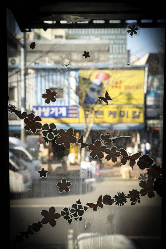 깨친 창문에 예쁜 스티커가 붙여져 있다. 창 밖으로는 을지로 공업사 가게들이 보인다. 장진영 기자