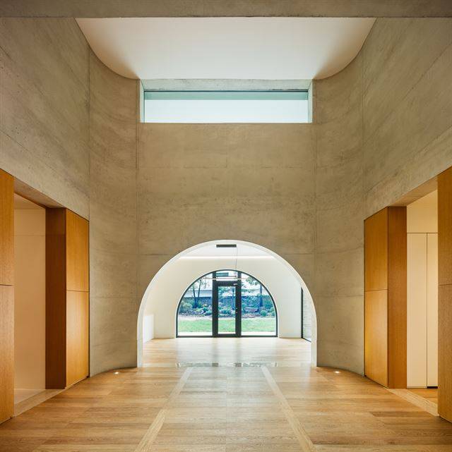 천장을 터서 2층 높이가 된 거실 벽을 콘크리트로 둥글게 감쌌다. 아치의 호와 모서리의 곡면이 조화를 이룬다. 신경섭 건축사진작가 제공