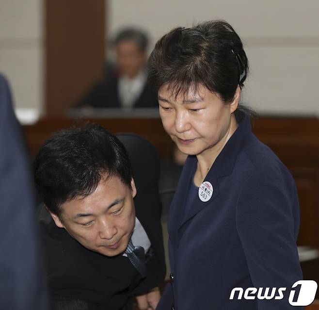 뇌물혐의 등으로 구속 기소된 박근혜 전 대통령이 서울 서초동 서울중앙지방법원417호 형사대법정에서 열린 첫 정식재판에 출석하며 유영하 변호사의 안내를 받고 있다. 2017.5.23/뉴스1 © News1 사진공동취재단