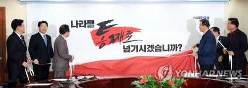 지방선거 슬로건 공개하는 자유한국당 (서울=연합뉴스) 최재구 기자 = 자유한국당 홍준표 대표 등 당직자들이 25일 서울 여의도 당사에서 열린 지방선거 슬로건 및 로고송 발표 행사에서 '나라를 통째로 넘기시겠습니까?'라는 슬로건을 공개하고 있다.     jjaeck9@yna.co.kr