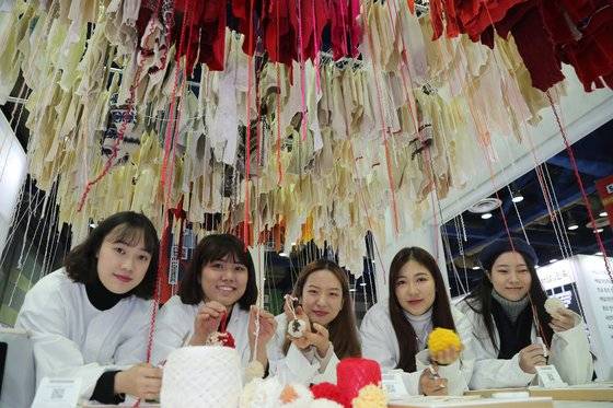 12일 오전 스웨터를 해체해 만든 크리스마스 장식품을 들고 있는 모습. 난민 어린이들을 위해 기증된다.