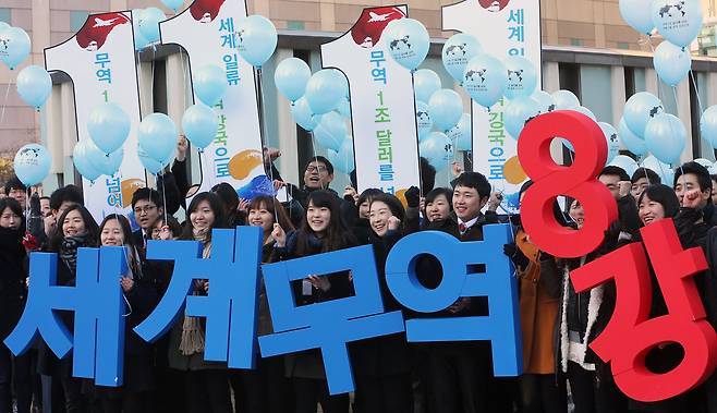 2012년 제49회 무역의 날. 서울 삼성동 무역센터 앞에서 한국무역협회와 관계사 임직원들이 우리나라 무역이 2년 연속 1조 달러 규모를 달성하고 사상 최초로 세계 8강에 등극하는 것을 축하하기 위한 퍼포먼스를 하고 있다. [연합뉴스]