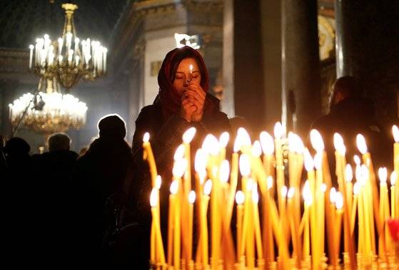 6일(현시시간) 성탄전야 러시아 상트페테르부르크그 카잔 성당에서 한 여성이 기도를 올리고 있다. [로이터=연합뉴스]