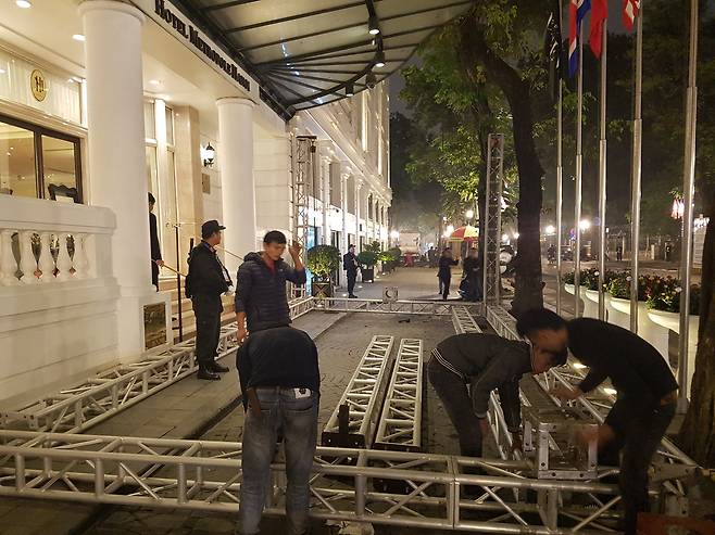 26일(현지시간) 북미가 정상회담을 가질 것으로 알려진 베트남 하노이 메트로폴 호텔 신관 입구와 호텔 VIP 차고지 앞에서 회담과 관련이 있어 보이는 구조물 설치 작업이 한창이다. [연합뉴스]