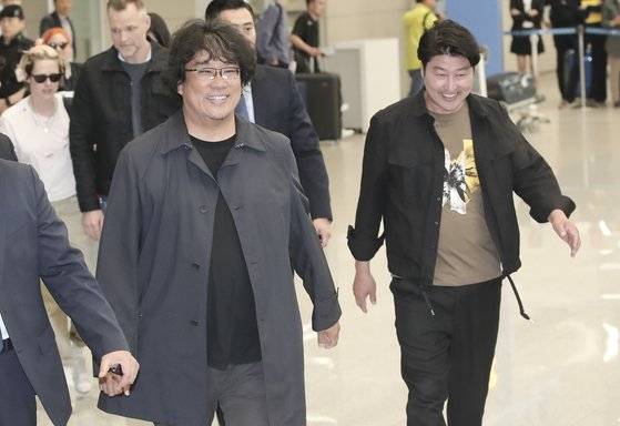 칸영화제에서 황금종려상을 수상한 봉준호 감독과 배우 송강호씨가 27일 오후 인천공항을 통해 입국하고 있다. 변선구 기자