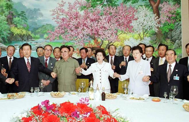 지난 2000년 6월15일 남북정상회담 당시 평양 백화원 영빈관에서 열린 남측대표단 환송오찬 헤드테이블에서 김대중대통령, 김정일 국방위원장, 이희호여사, 임동원 당시 국정원장 등과 함께 손을 잡고 `우리의 소원'을 합창하고 있다. [중앙포토]