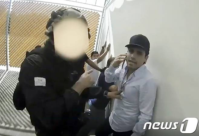 멕시코 특경대에 체포된 마약왕 구스만의 아들 오비디오의 모습. 전화로 공격을 멈추라 지시했지만 조직원들의 거센 저항이 지속되자 경찰은 그를 다시 풀어주고 말았다. 당시 체포 작전에 나섰던 경찰이 갱단에 암살 당했다. © AFP=뉴스1