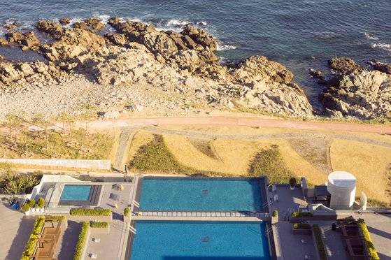 호텔 힐튼 부산에서 내려다본 워터하우스, 해안 산책로와 갯바위가 야외 온천 발치에 있다. 백종현 기자