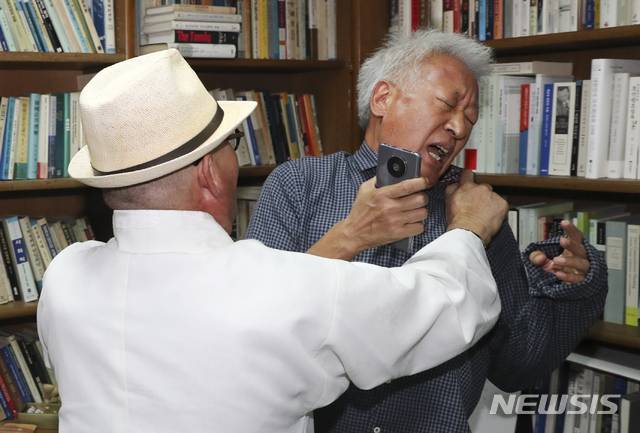 【서울=뉴시스】뉴시스 최진석 기자가 22일 한국사진기자협회 선정 제201회 이달의 보도사진상 spot news 부문에서 "멱살 잡힌 '위안부' 매춘 발언 파문 류석춘 교수"로 최우수상을 수상했다. 사진은 지난 9월 24일 일본군 '위안부'가 매춘의 일종이었다고 발언해 파문을 일으킨 류석춘 연세대 사회학과 교수(오른쪽)가 서울 서대문구 연세대 연구실에 항의 방문한 한 시민단체 회원에게 멱살을 잡히는 모습. 2019.10.22. photo@newsis.com