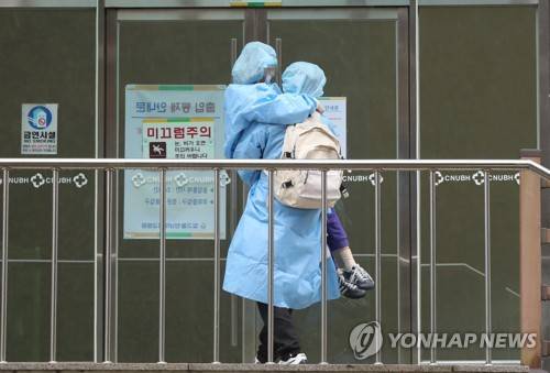 앞으로는 딸을, 등에는 짐을 (광주=연합뉴스) 박철홍 기자 = 7일 오후 광주 남구 빛고을전남대병원에서 대구에서 온 코로나19 확진자가 거동이 불편한 자녀를 직접 안아 옮기고 있다. 2020.3.7 pch80@yna.co.kr