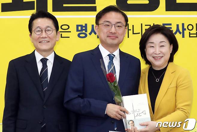 심상정 정의당 대표와 윤소하 원내대표가 지난 8일 서울 여의도 국회에서 열린 21대 국회의원 총선거 비례대표 후보자 선출보고회에서 비례대표 6번에 선정된 신장식 당 사법개혁특위원장 에게 장미꽃과 노회찬 회고록을 전달하고 있다. 2020.3.8/뉴스1 © News1 김명섭 기자
