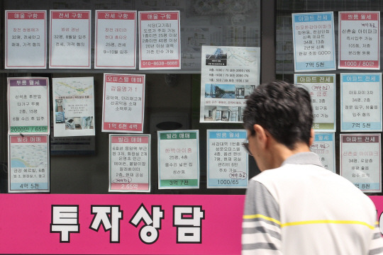급매물마저 끊기고… : 지난 4월 한 달 서울 아파트 거래량이 3월과 비교해 3분의 1 가까이 감소한 것으로 나타난 가운데 지난달 31일 서울 시내 한 부동산 중개사무소 앞을 행인이 지나가고 있다.  연합뉴스