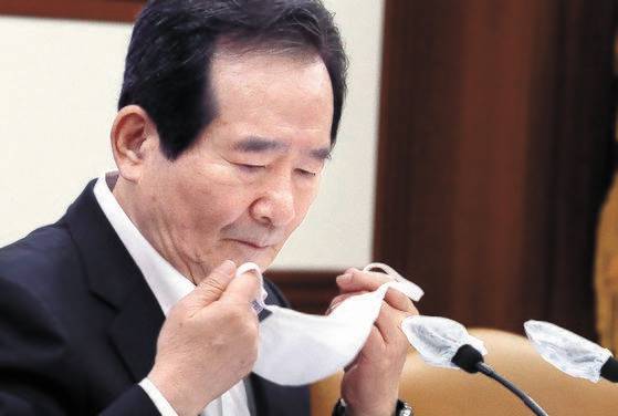 정세균 국무총리가 8일 정부서울청사에서 열린 국제개발협력위원회에 참석하며 마스크를 벗고 있다. 정 총리는 이날 내년 보건·의료 분야 공적개발원조 예산을 확대하기로 결정했다. [뉴시스]