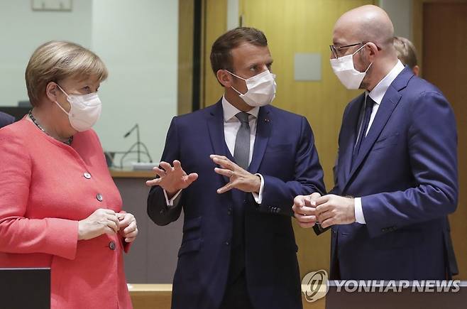 샤를 미셸 EU 정상회의 상임의장(오른쪽부터)과 에마뉘엘 마크롱 프랑스 대통령, 앙겔라 메르켈 독일 총리가 17일(현지시간) 벨기에 브뤼셀에서 열린 EU 정상회의에서 대화하고 있다. [AP=연합뉴스]