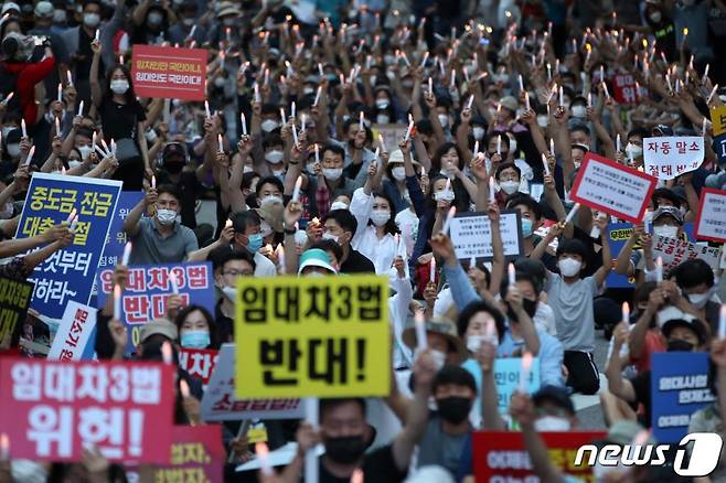 부동산 규제에 반발하는 시민들이 25일 저녁 서울 중구 예금보험공사 앞에서 '부동산 규제정책 반대, 조세저항 촛불집회’를 하고 있다./사진=뉴스1