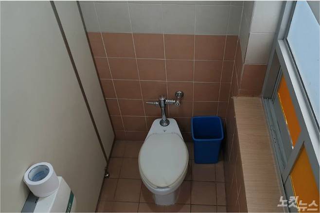 지난해 명지전문대에서 일하는 한 청소 노동자가 휴게실로 썼던 화장실 한 칸. 현재는 냉장고 등 개인 물품이 치워진 상태다. 하지만 총 8개 층인 해당 건물에는 여전히 미화원 휴게실이 없다. (사진=박하얀 기자)