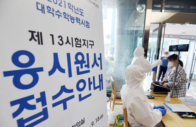 2021학년도 대학수학능력시험 원서접수가 시작된 3일 오전 서울 영등포구 남부교육지원청에서 수험생이 원서 접수에 앞서 체온을 측정하고 있다. [뉴스1]