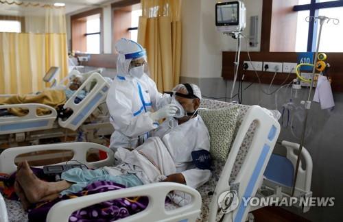 인도 뉴델리의 한 병원에서 코로나19 환자를 돌보는 의료진(왼쪽). [로이터=연합뉴스]