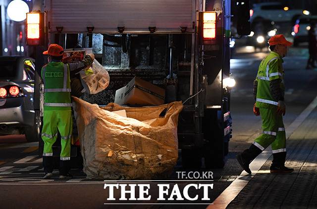 늦은밤 재활용 쓰레기를 수거하는 환경미화원들.