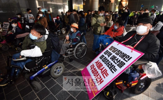 서울장애인차별철폐연대가 지난 13일 서울 중구 서울시청 후문에서 기자회견을 열고 서울시가 코로나19를 핑계로 내년도 중증장애인 예산을 삭감하고 있다며 무기한 농성 투쟁을 결의하고 있다.박지환 기자 popocar@seoul.co.kr