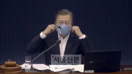 문재인 대통령이 3일 청와대 여민관 영상회의실에서 열린 제55회 국무회의를 마치기 전 만화의 날을 맞아 문화체육관광부가 제작한 웹툰 마스크를 써보이고 있다. 청와대 제공