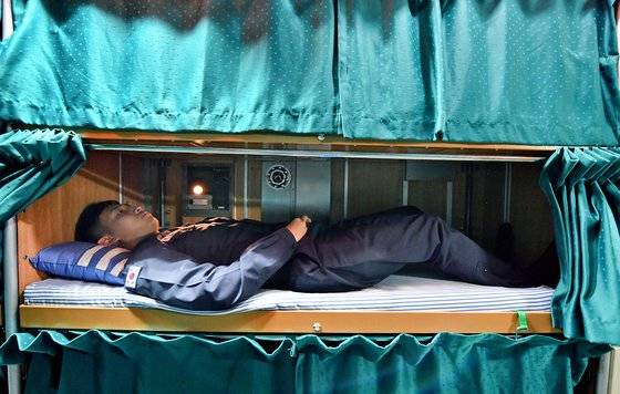 비좁은 잠수함 내부 침대에서 한 승조원이 쉬고 있다. 1m80㎝가 넘는 사람은 다리를 채 다 펴지 못한다. [사진=해군]