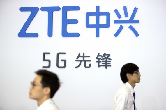 지난 2018년 9월26일(현지시간) 중국 베이징 PT엑스포에 ZTE를 홍보하는 로고 앞을 관람객들이 지니가고 있다.AP뉴시스
