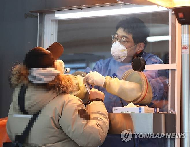 오늘도 검사 휴일인 지난 19일 오전 서울 중구 시청 앞 서울광장에 마련된 임시 선별진료소에서 의료진이 검체를 채취하고 있다. [연합뉴스 자료사진]