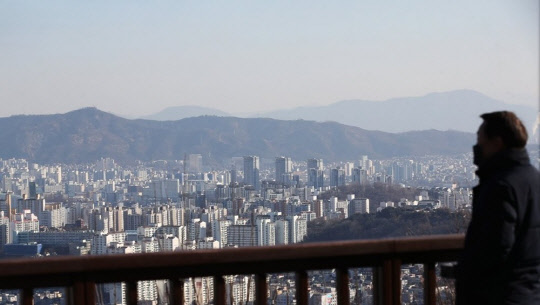 한 시민이 서울 남산에서 서울 도심 아파트 밀집 지역을 바라보고 있다.



연합뉴스