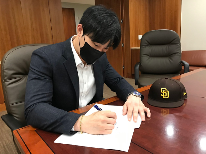 내야수 김하성이 지난 1일(한국시간) 미국 메이저리그 샌디에이고 파드리스 구단과의 계약서에 서명하고 있다. /사진=샌디에이고 파드리스 공식 트위터