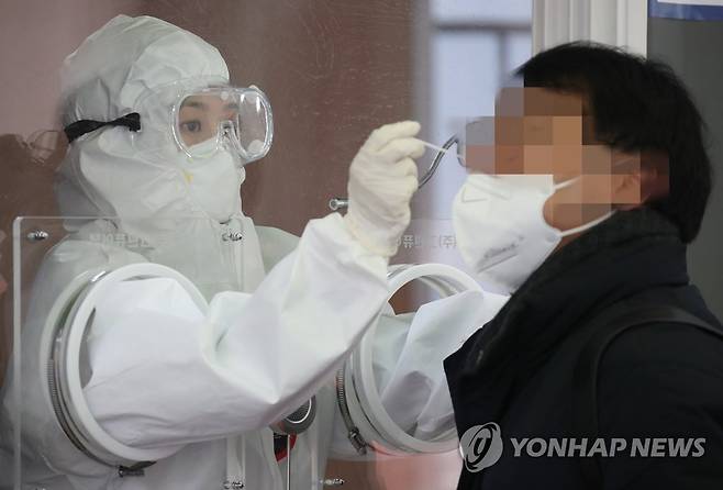 '잠깐만 참으세요' (서울=연합뉴스) 김도훈 기자 = 4일 오전 서울역 광장에 설치된 서울 중구 임시 선별검사소에서 의료진이 검체 검사를 실시하고 있다. superdoo82@yna.co.kr
