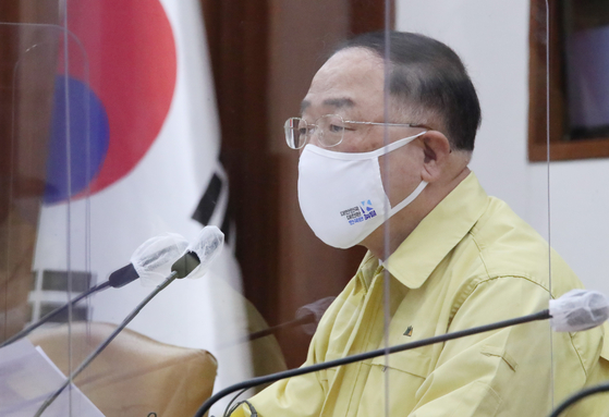 Finance Minister Hong Nam-ki attending the government meeting in Seoul on Wednesday. [YONHAP]