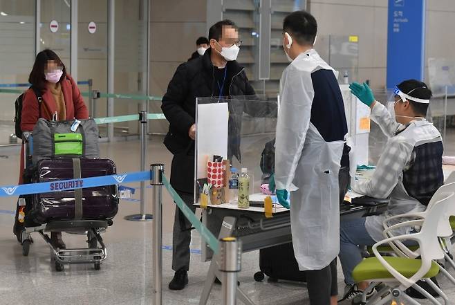 ▲ 8일 오후 인천국제공항 제2여객터미널에서 방역 관계자들이 해외 입국자들에게 동선을 안내하고 있다. 박태현 기자