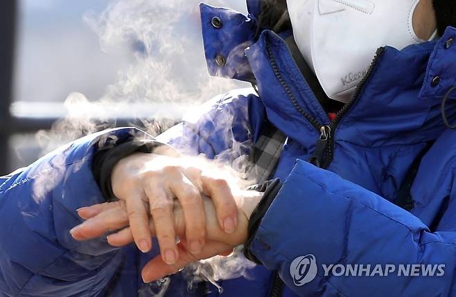 최강한파에 손에서 나오는 것은... (서울=연합뉴스) 한상균 기자 = 8일 오전 서울역광장 임시선별진료소에서 한 시민이 손 소독을 하자 강추위에 김이 나고 있다. 지난 7일부터 한파로 수도권 임시 선별검사소는 운영시간을 3∼5시간가량 단축했다. 2021.1.8 xyz@yna.co.kr