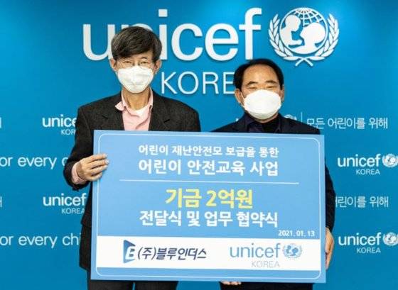 블루인더스 대표 정천식 SBO리그 총재(오른쪽)가 13일 서울 유니세프한국위원회를 찾아 이기철 사무총장에게 어린이 안전 교육사업 기금 2억원을 전달하고 업무 협약식을 체결했다.