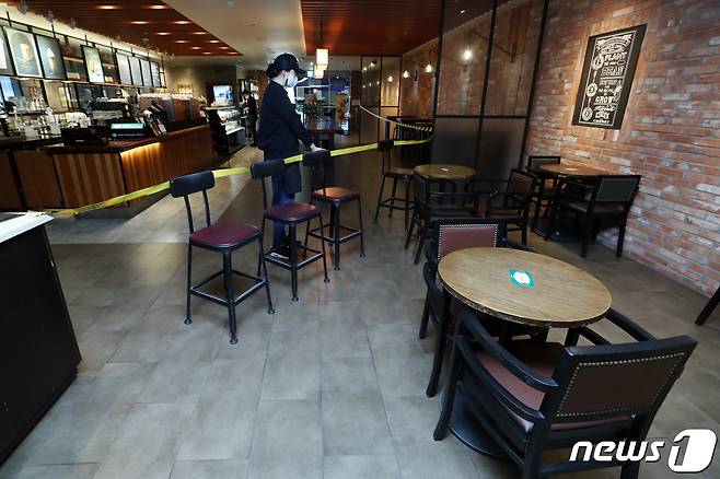 오는 18일부터 카페 매장 내 취식이 가능해진다. 정부는 지난 16일 발표한 신종 코로나바이러스 감염증(코로나19) '사회적 거리두기' 조정안을 통해 전국 카페에서 오후 9시까지 매장 내 취식이 가능하다고 밝혔다. 17일 서울의 한 커피 전문점에서 매장 한 켠으로 치워놨던 탁자와 의자가 다시 제자리로 옮겨 정리돼 있다. 2021.1.17/뉴스1 © News1 민경석 기자