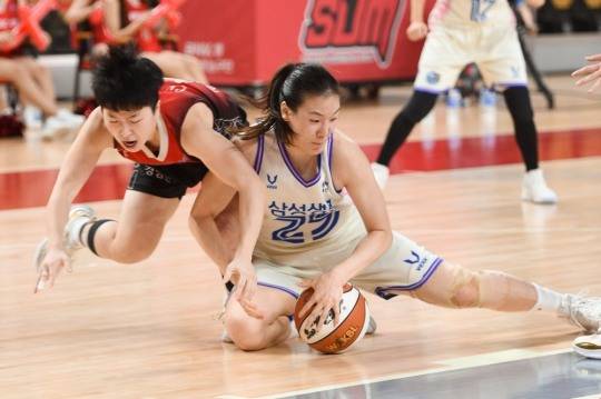 22일 삼성생명 배혜윤(흰색 유니폼)이 BNK 안혜지와 루스볼 다툼을 하고 있다.  
[WKBL 제공]