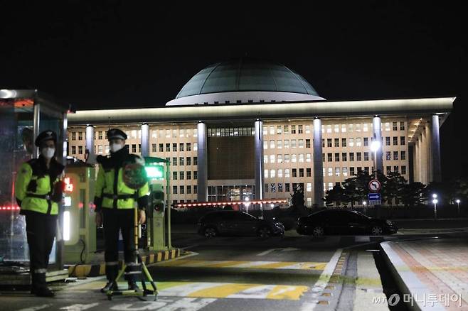 [서울=뉴시스]박민석 기자 = 한 고교생이 국회의사당을 폭파하겠다는 거짓 신고를 한 25일 오후 서울 여의도 국회 입구에서 경찰이 근무를 하고 있다. 2021.01.25. mspark@newsis.com