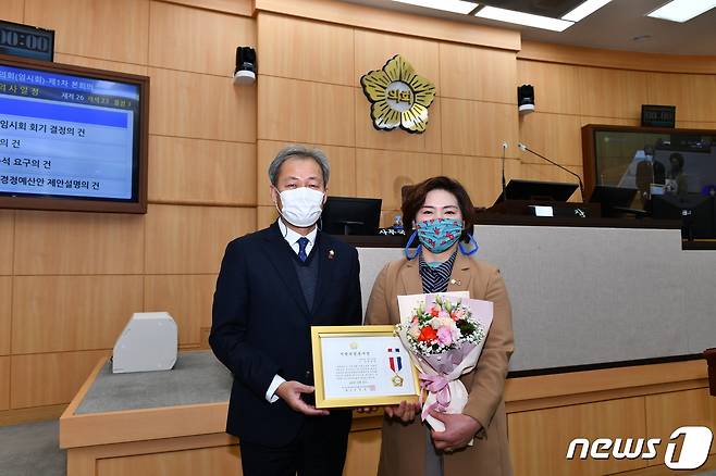 박성미 여수시의원(오른쪽)이 25일 여수시의회 본회의장에서 전창곤 의장으로부터 지방의정 봉사상을 받고 있다.(박성미 의원 제공)/뉴스1 © News1