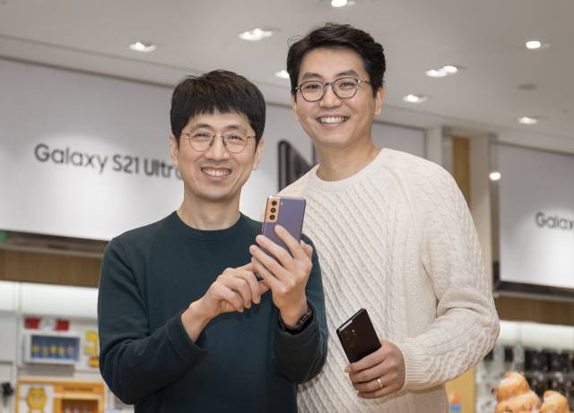 최지환(왼쪽)·여동원 삼성전자 비주얼소프트웨어 그룹 소속 프로가 갤럭시S21을 들고 포즈를 취하고 있다. /삼성전자