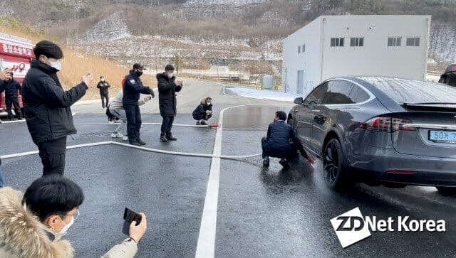 이달 5일 충청남도 공주 중앙소방학교에서 진행된 테슬라 챠량 관련 안전교육 현장. 테슬라 모델 X 차량 아랫쪽 리튬이온배터리 화재 진압 방법 시연이 진행되고 있다.