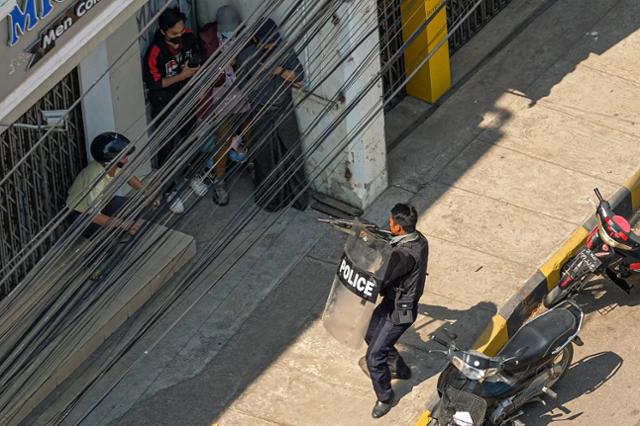 지난달 28일 미얀마 타웅지에서 경찰이 시민들에게 총을 겨누고 있다. 타웅지=AFP 연합뉴스